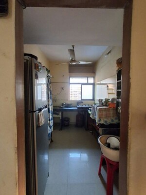 Kitchen in 1 BHK Apartment at Raunak Charnamrut CHS, Ghodbunder Road – for Rent